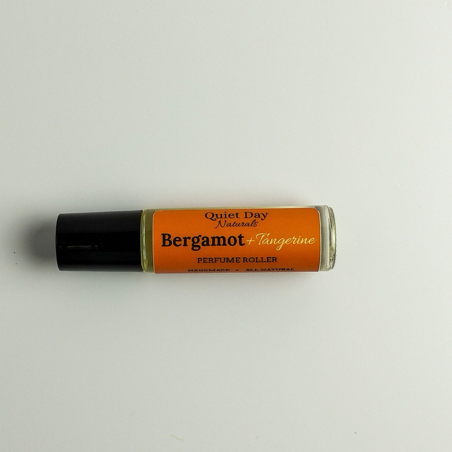 All-Natural Perfume Roller laying against a white background.