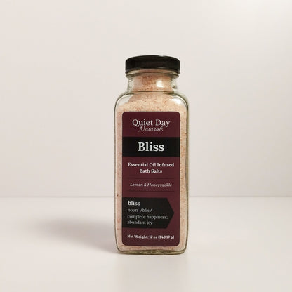 Bliss Bath Salt in a glass jar sitting against a white background.