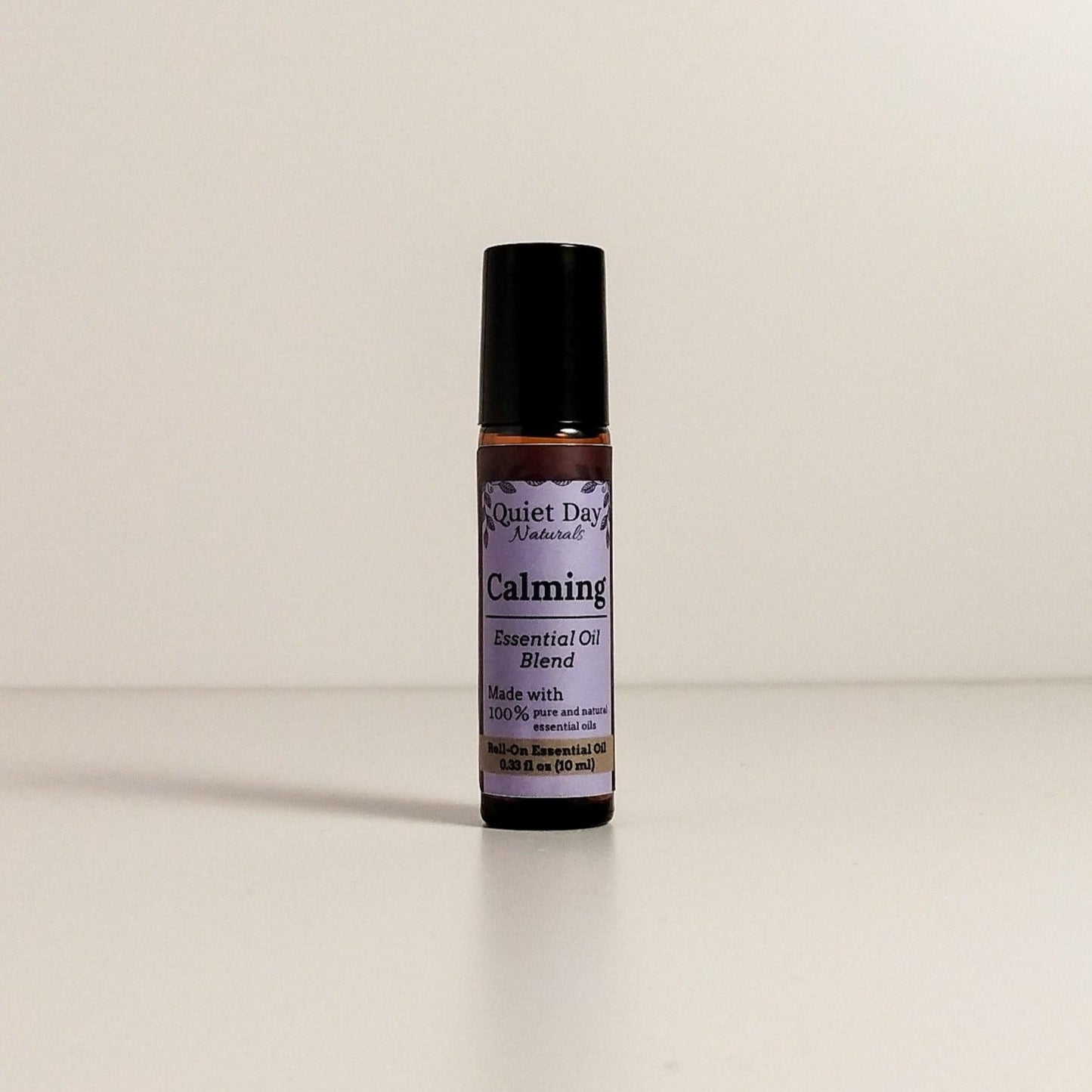 Calming Essential Oil Roller sitting against a white background.