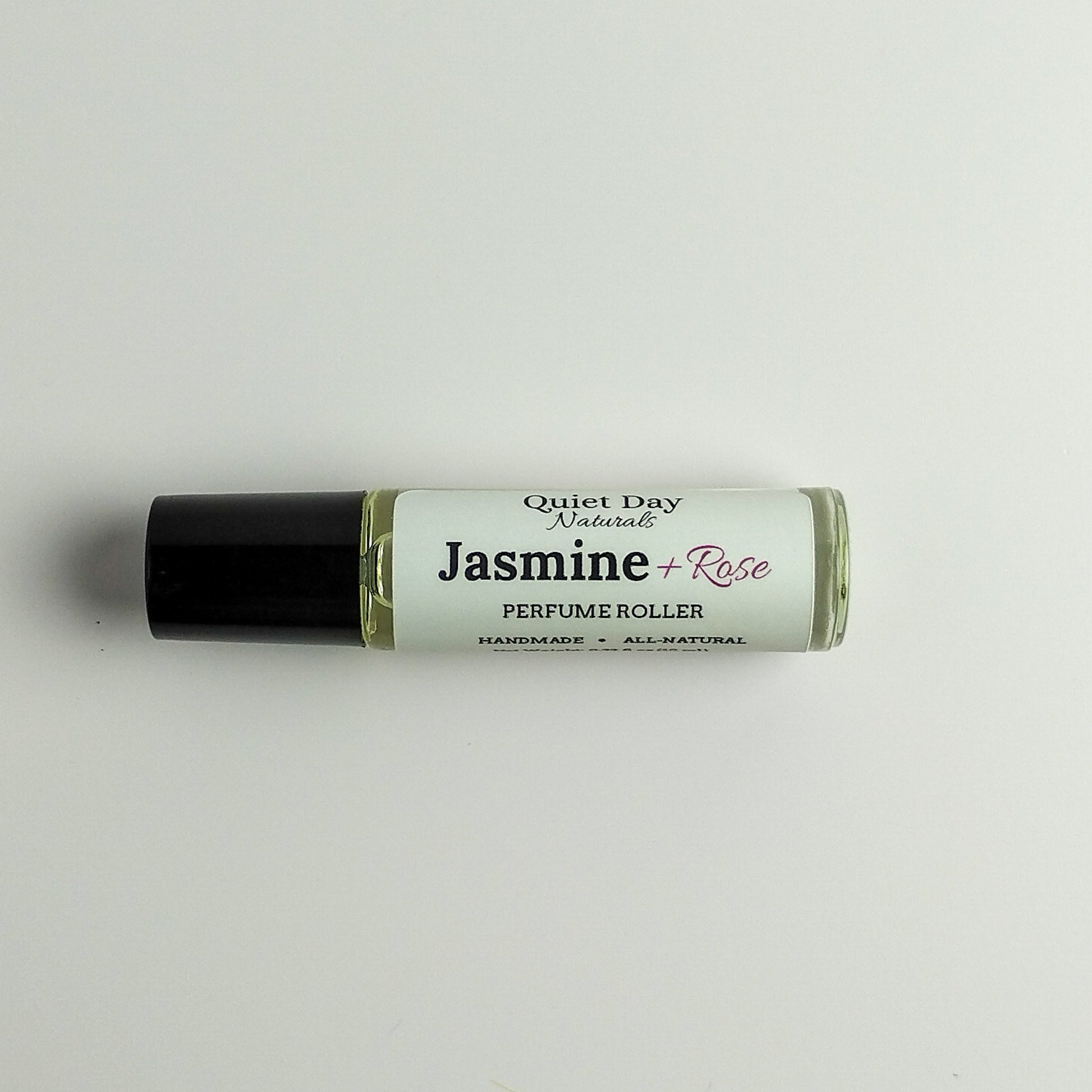 All-Natural Perfume Roller laying against a white background.