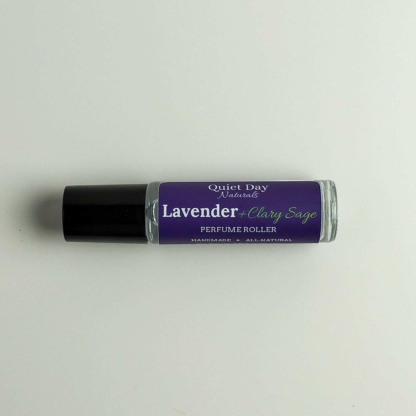 All-Natural Perfume Roller laying against a white background.