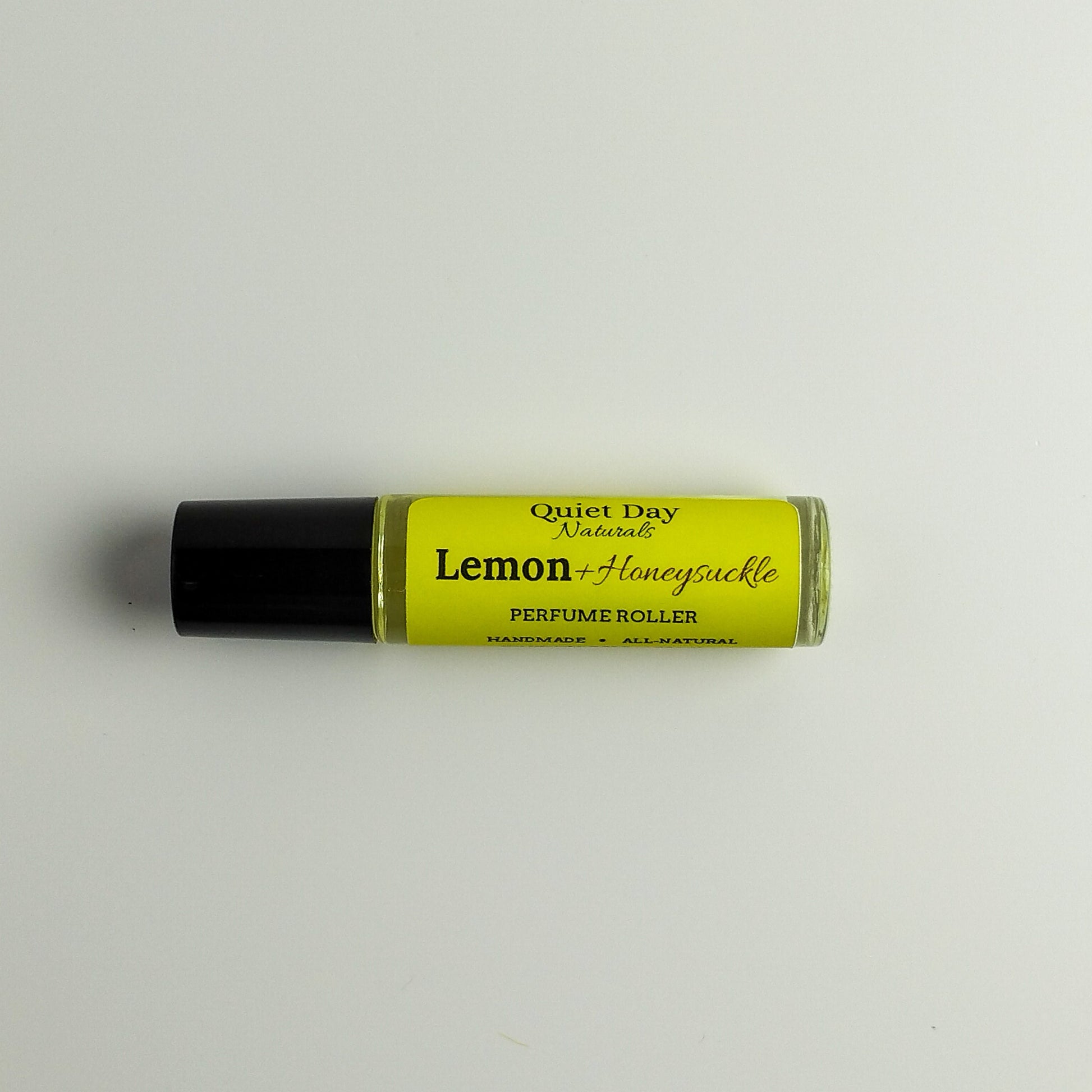 All-Natural Perfume Roller laying against a white background.