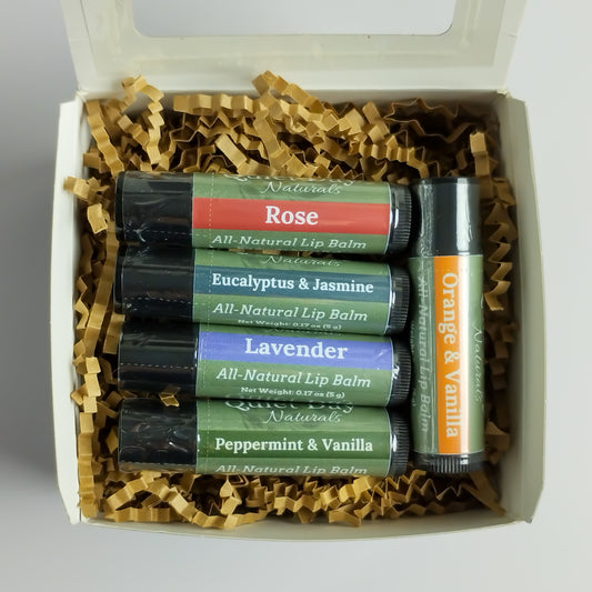 Natural Lip Balm Variety Pack including Rose, Eucalyptus & Jasmine, Lavender, Peppermint & Vanilla, Orange & Vanilla sitting against a white background.