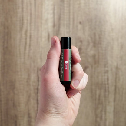 Paraben free lip balm being held in hand to show size.