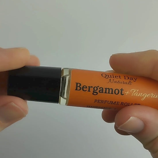 Video showing Perfume Roller being applied to wrist and giving close-up of product label.