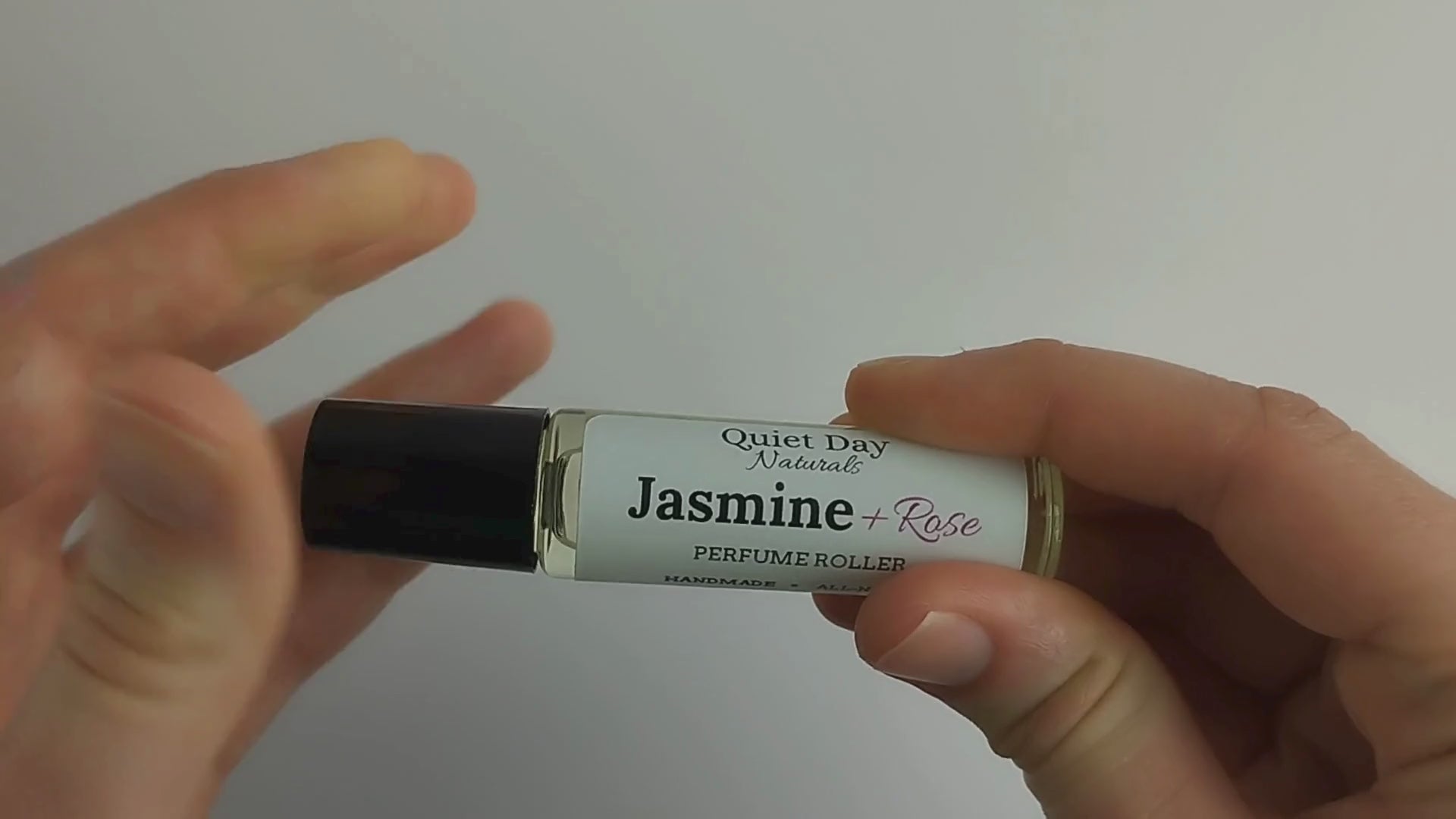 Video showing Perfume Roller being applied to wrist and giving close-up of product label.